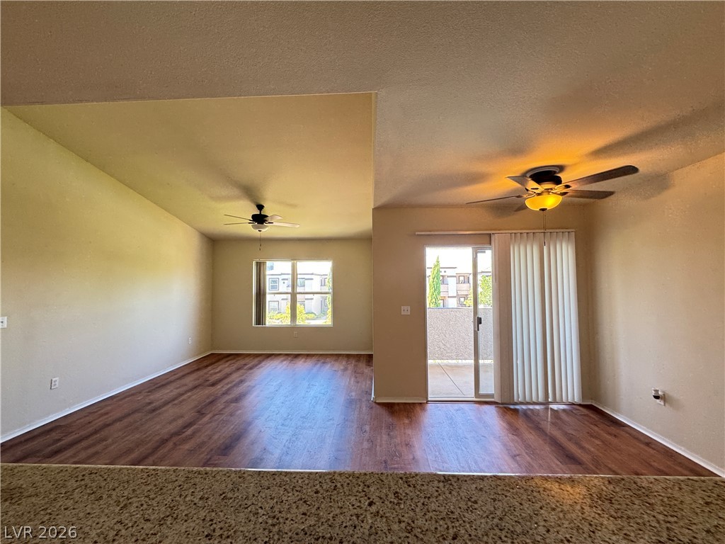 7255 West Sunset Road, Unit 2111 Las Vegas, NV 89113 - Photo 8 of 33 A living space offers direct outdoor access and polished hardwood-style flooring.