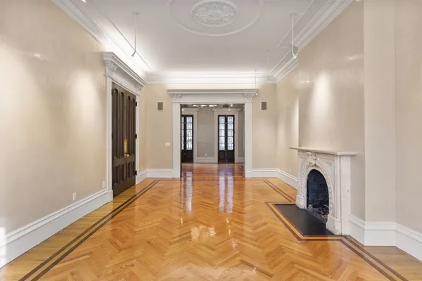 a view of empty room with a fireplace and fan