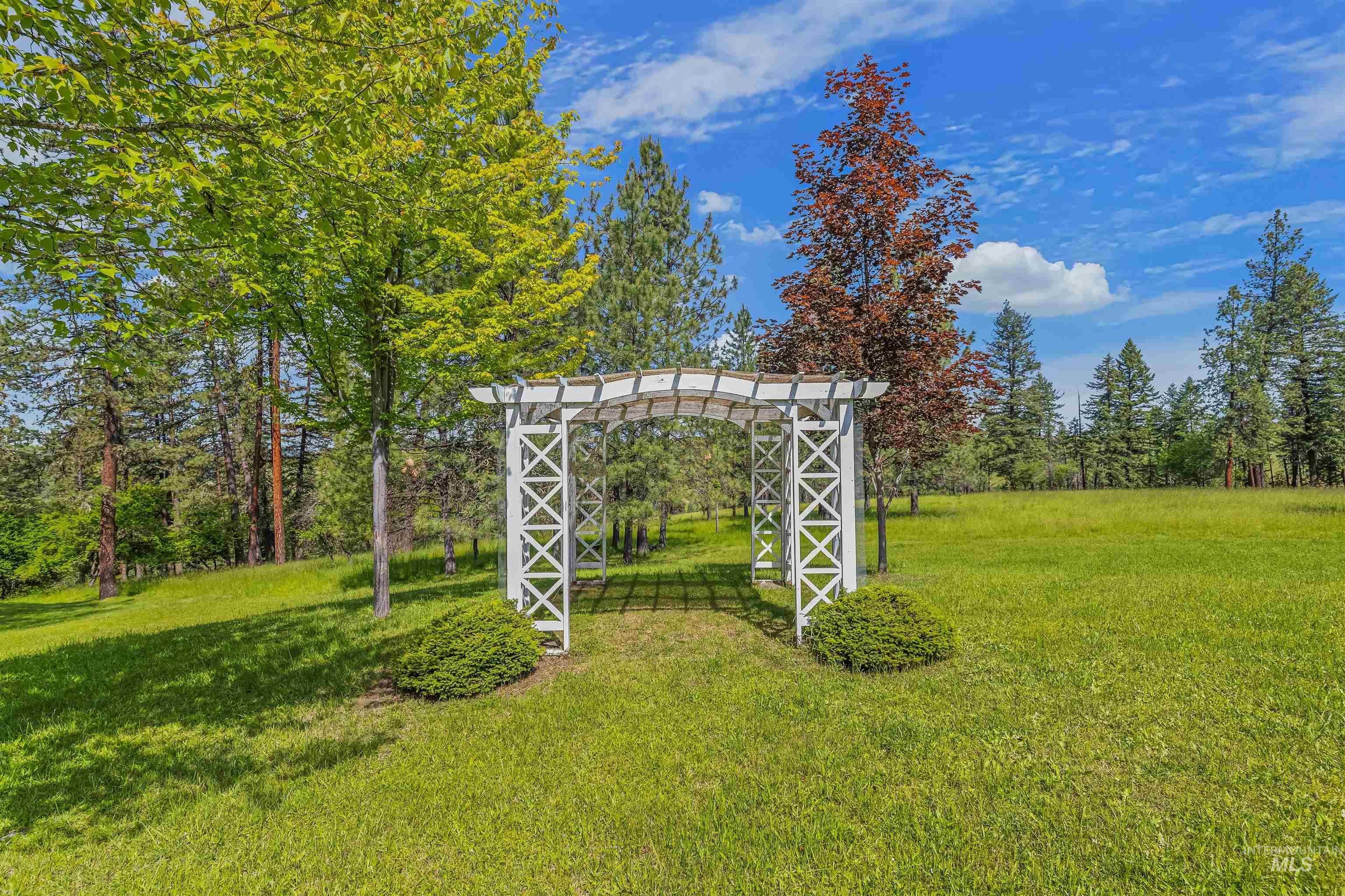 743 Wall Crk Road Stites, ID 83552 - Photo 13 of 48 Open lawn area featuring a white pergola structure