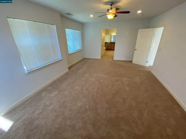a large bathroom with a sink double vanity granite and a mirror