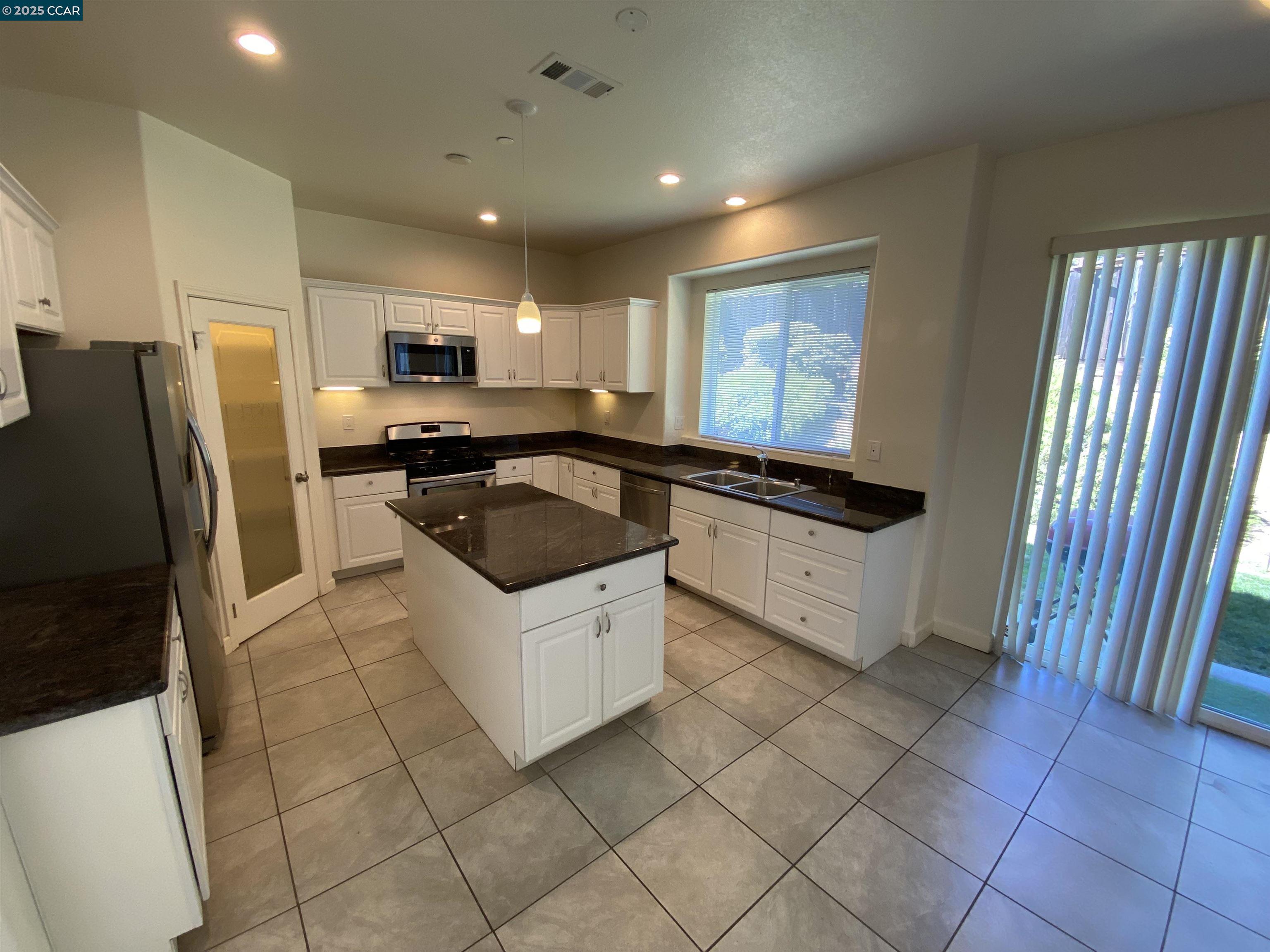 1900 La Veranda Place Martinez, CA 94553 - Photo 9 of 57 a kitchen with a sink a refrigerator and cabinets