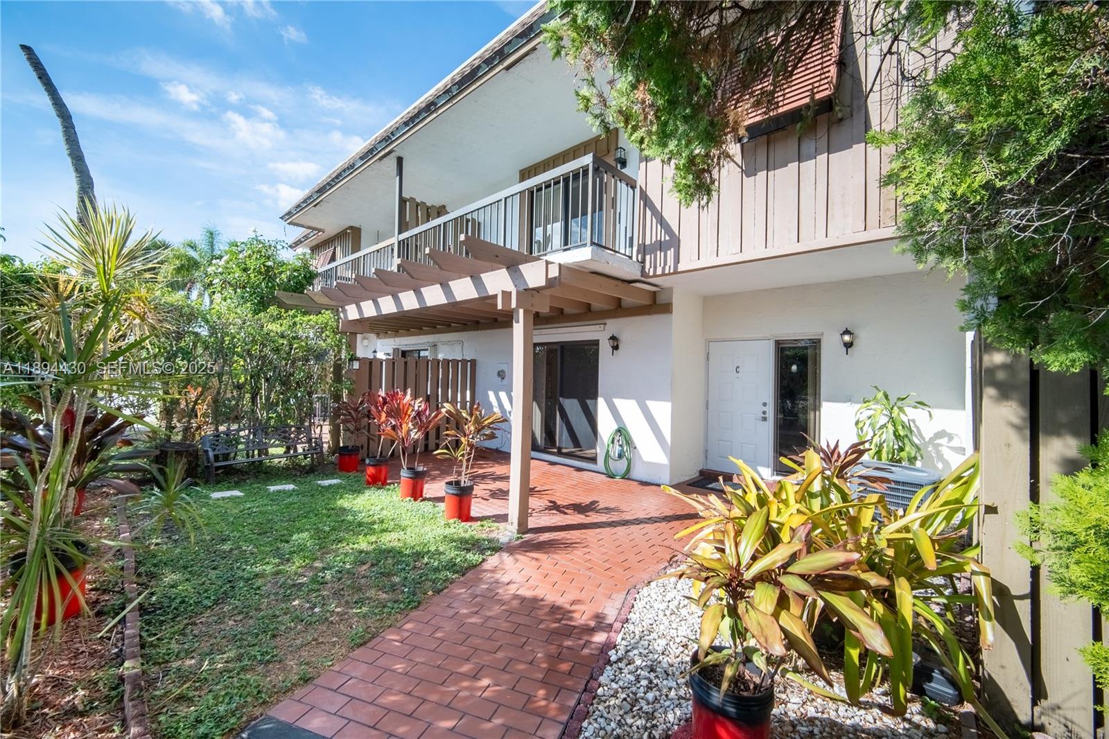 6845 Northwest 169th Street, Unit 41C Hialeah, FL 33015 - Photo 1 of 20 front view of a house with a yard