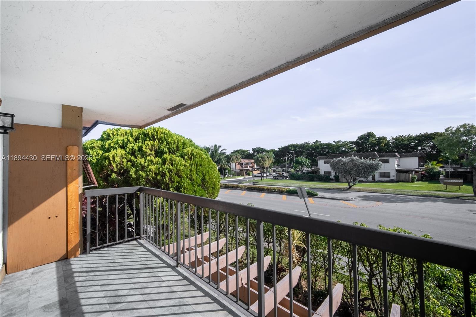 6845 Northwest 169th Street, Unit 41C Hialeah, FL 33015 - Photo 13 of 20 a view of a balcony with wooden fence