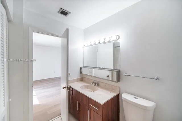 a bathroom with a toilet a sink and shower
