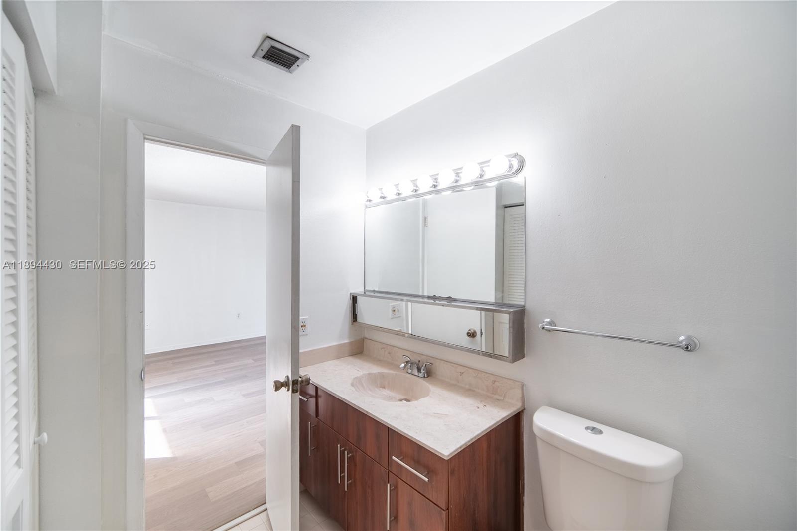 6845 Northwest 169th Street, Unit 41C Hialeah, FL 33015 - Photo 15 of 20 a bathroom with a sink vanity and a mirror