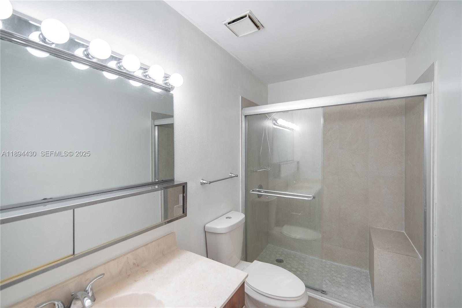 6845 Northwest 169th Street, Unit 41C Hialeah, FL 33015 - Photo 16 of 20 a bathroom with a toilet a sink and shower