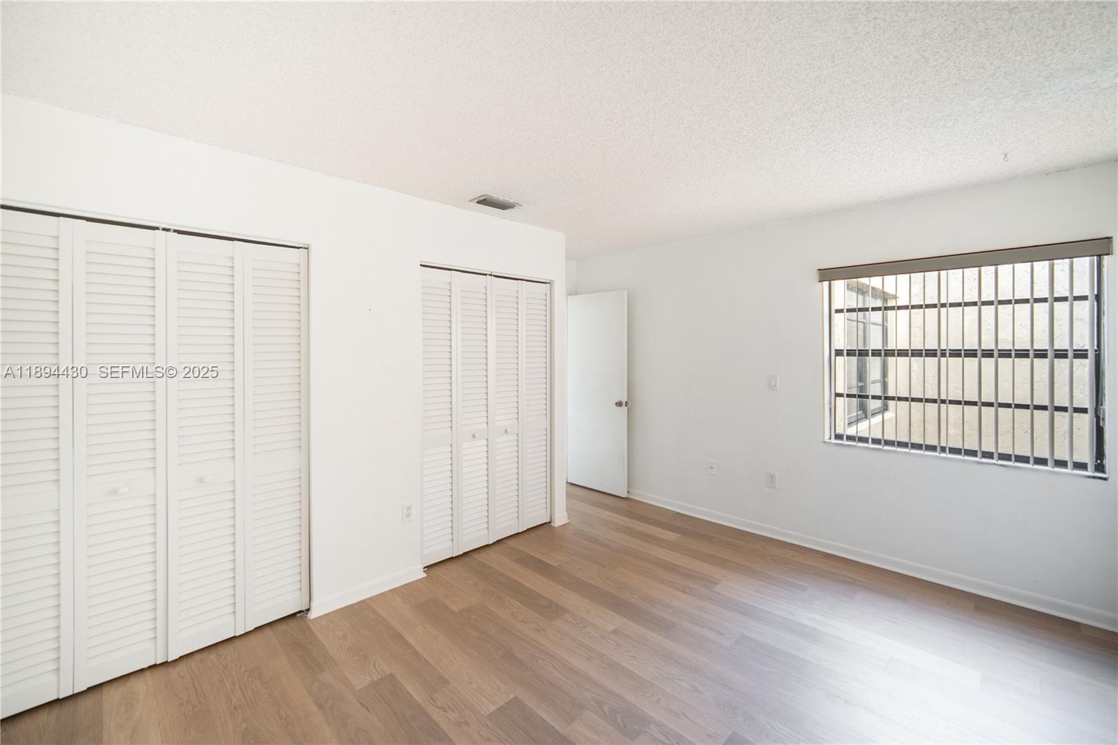 6845 Northwest 169th Street, Unit 41C Hialeah, FL 33015 - Photo 18 of 20 an empty room with windows