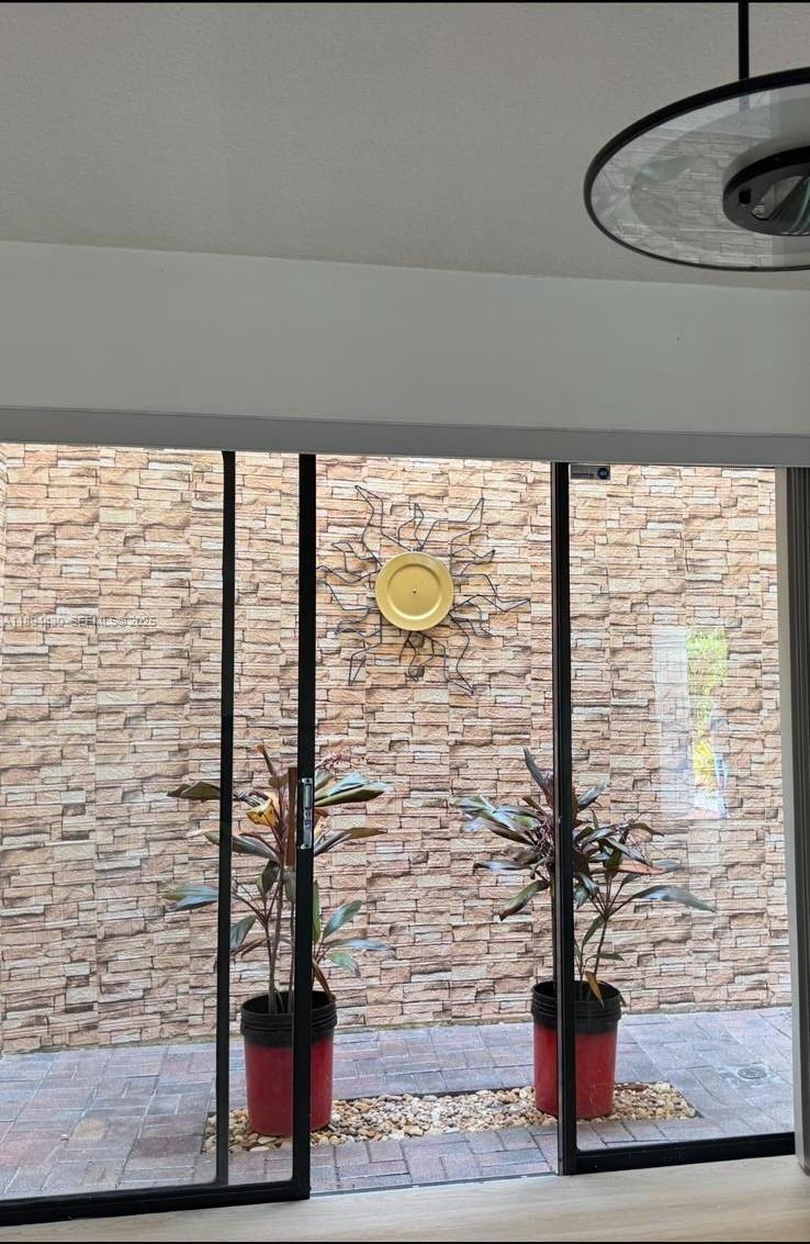 6845 Northwest 169th Street, Unit 41C Hialeah, FL 33015 - Photo 20 of 20 a vase of flowers sitting next to a window