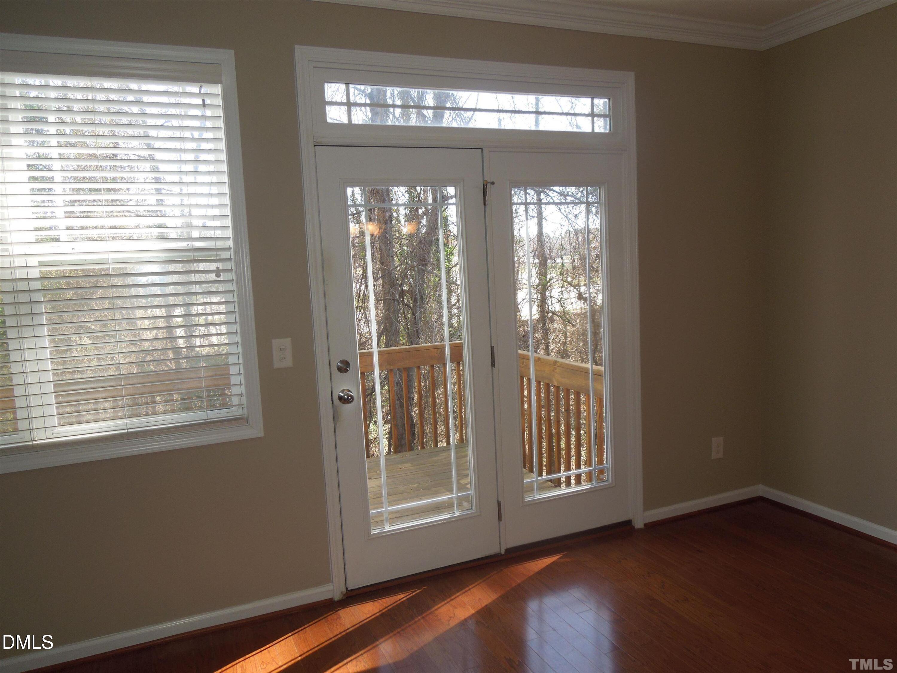 4622 Altha Street Raleigh, NC 27606 - Photo 3 of 8 a view of an empty room with wooden floor and a window