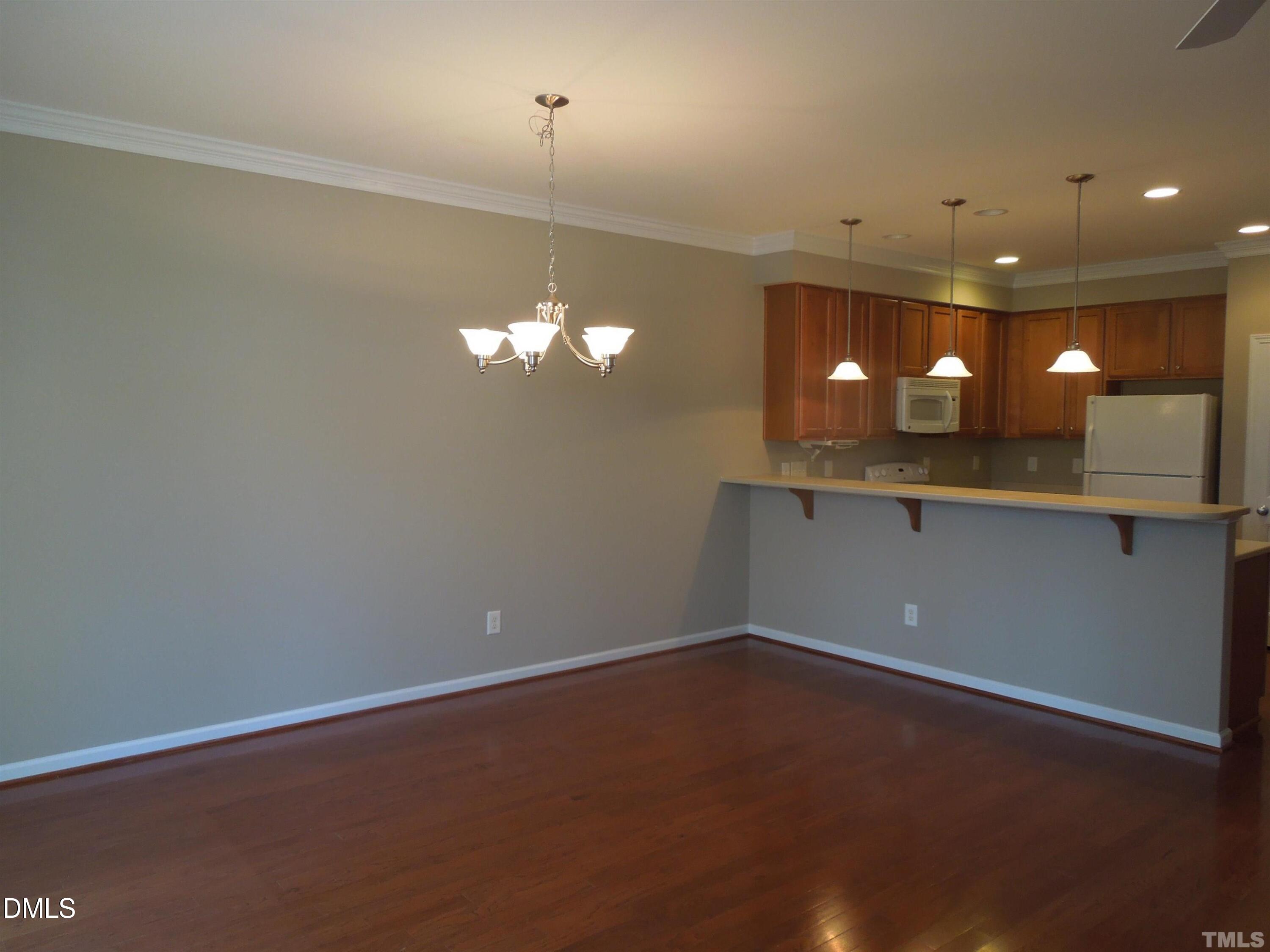 4622 Altha Street Raleigh, NC 27606 - Photo 4 of 8 a view of a chandelier fan and fire place