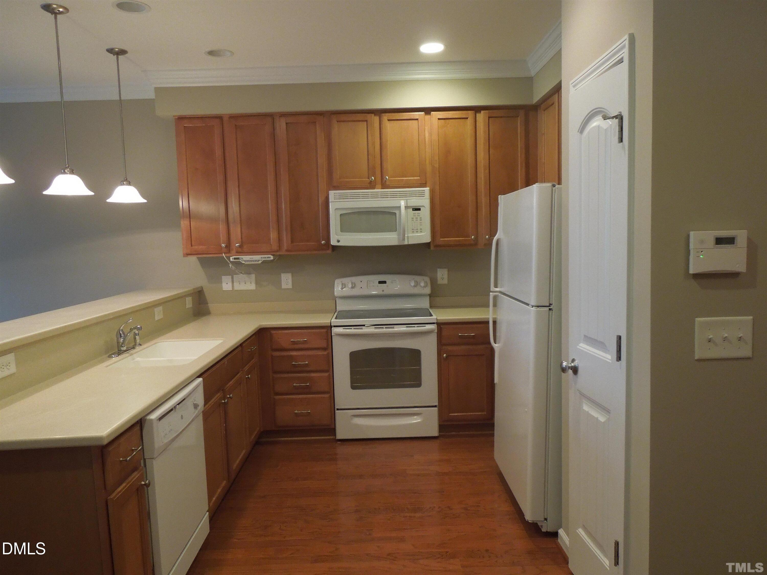 4622 Altha Street Raleigh, NC 27606 - Photo 5 of 8 a kitchen with a refrigerator and a sink