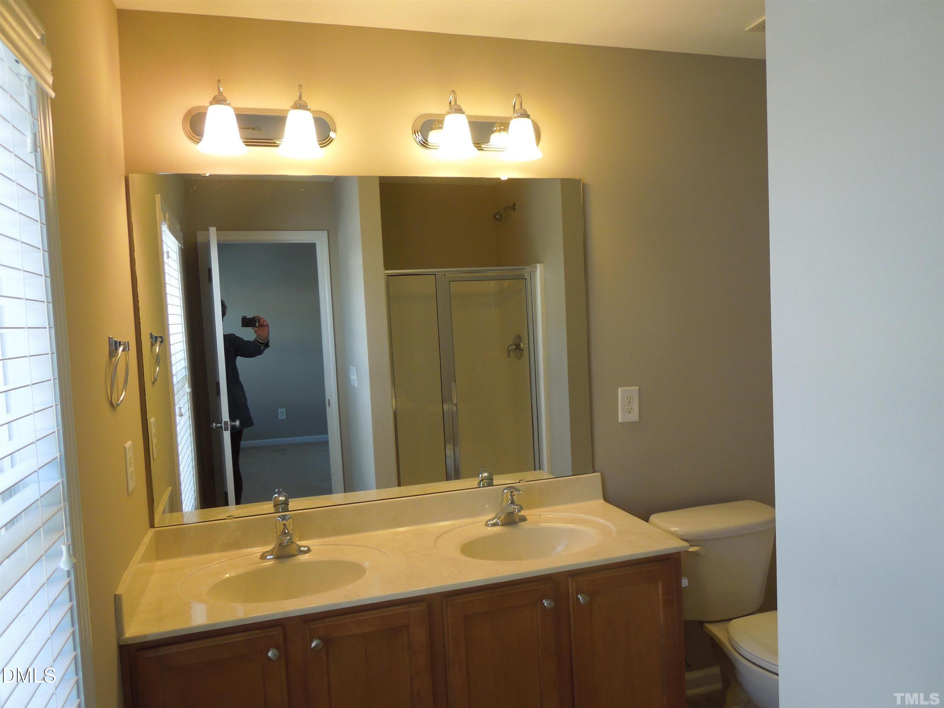 4622 Altha Street Raleigh, NC 27606 - Photo 6 of 8 a bathroom with a sink and a mirror