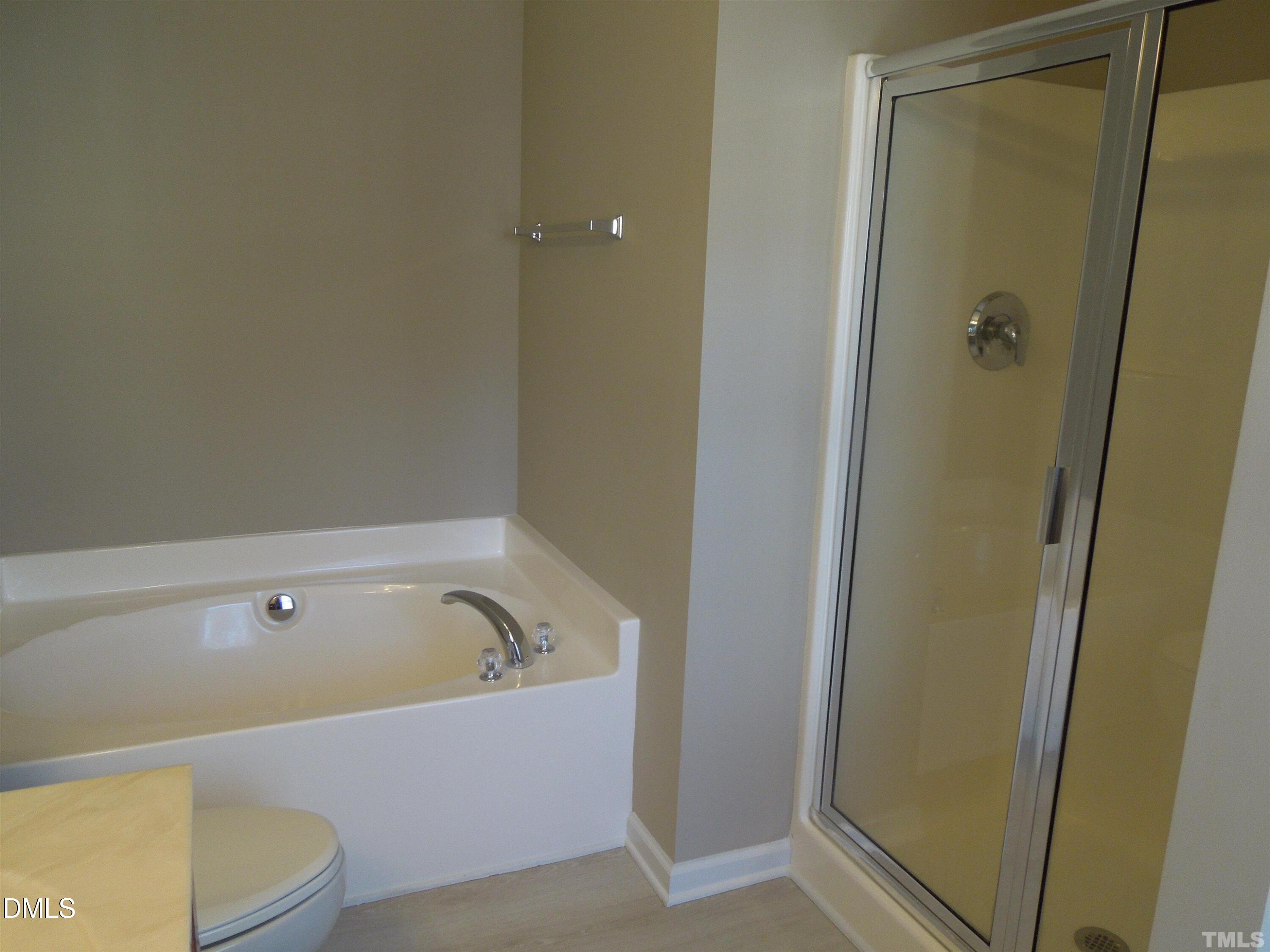 4622 Altha Street Raleigh, NC 27606 - Photo 7 of 8 a bathroom with a tub and shower
