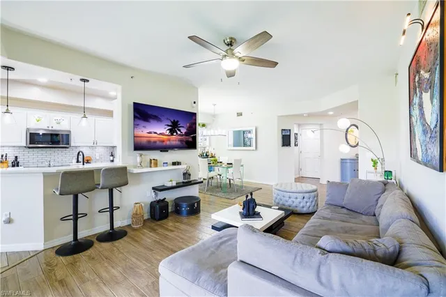 a living room with furniture and view of kitchen