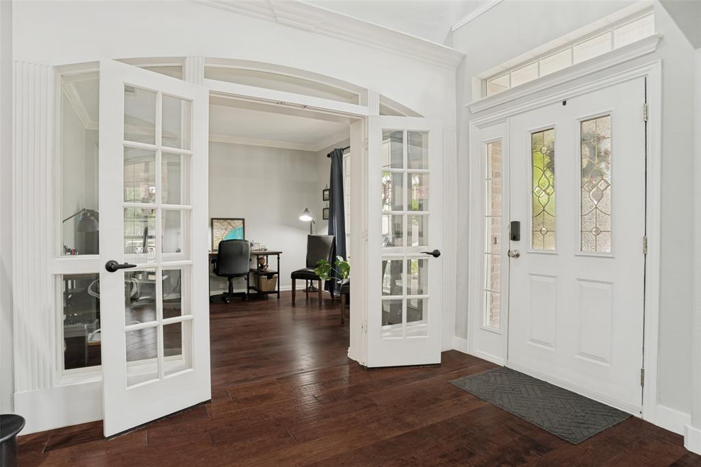 1612 Coventry Lane Allen, TX 75002 - Photo 2 of 39 Entryway featuring rich wood-finish flooring, white paneled double doors with decorative glass inserts, and a transom window