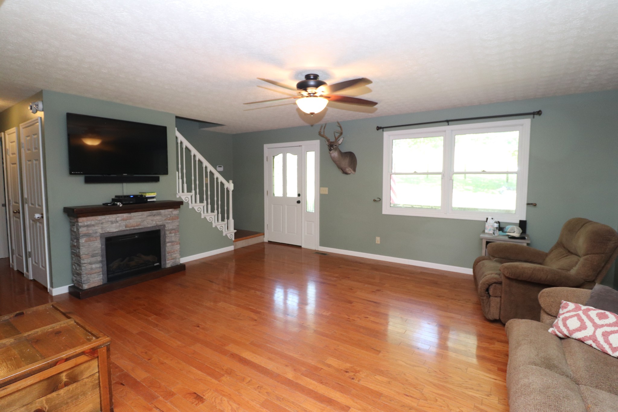 2724 Highland Road Lafayette, TN 37083 - Photo 3 of 39 a living room with furniture a flat screen tv and a fireplace