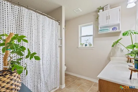 a bedroom with a bed chair and a window