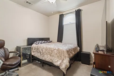 a bedroom with a bed and a desk