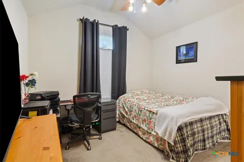 a bedroom with a bed and chair