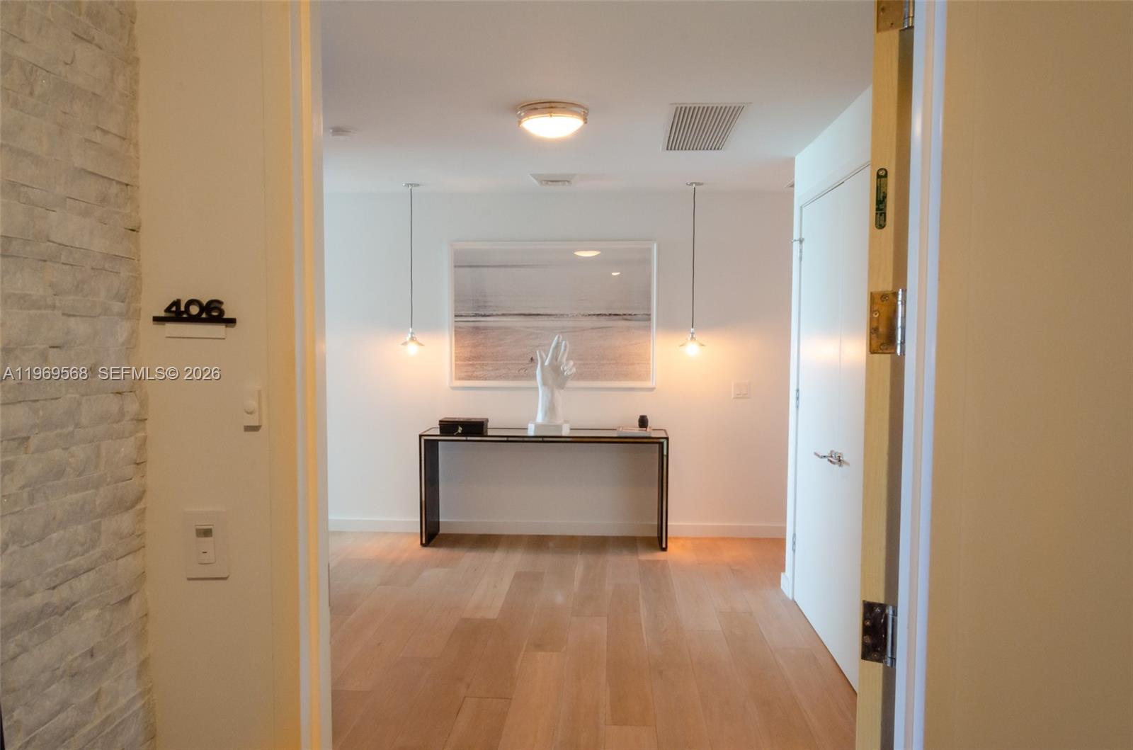 350 Ocean Drive, Unit 406N Key Biscayne, FL 33149 - Photo 6 of 41 a view of a hallway with wooden shelves