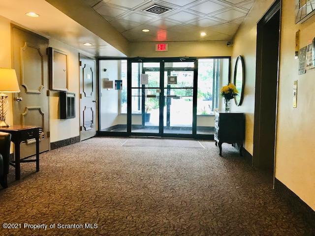 220 Linden Street, Unit 710 Scranton, PA 18503 - Photo 2 of 13 a living room with furniture and a chandelier