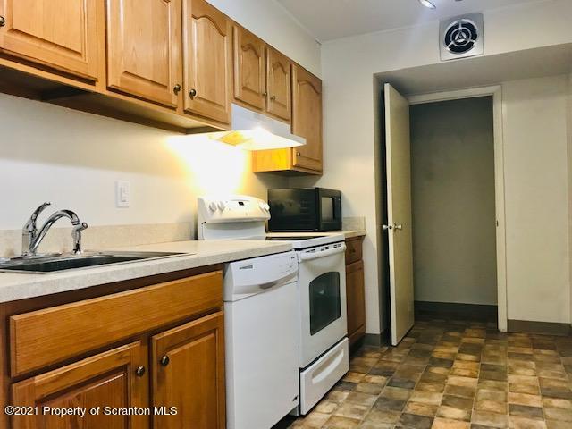 220 Linden Street, Unit 710 Scranton, PA 18503 - Photo 3 of 13 a kitchen with stainless steel appliances granite countertop a sink a stove and a refrigerator