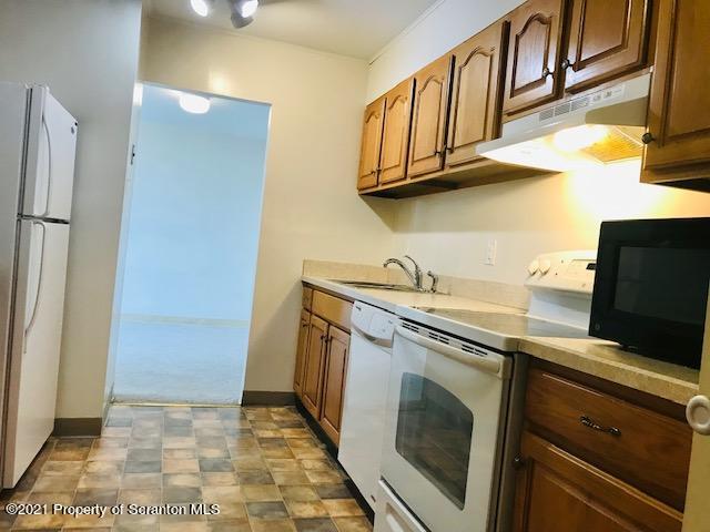 220 Linden Street, Unit 710 Scranton, PA 18503 - Photo 4 of 13 a kitchen with stainless steel appliances granite countertop a refrigerator and a stove
