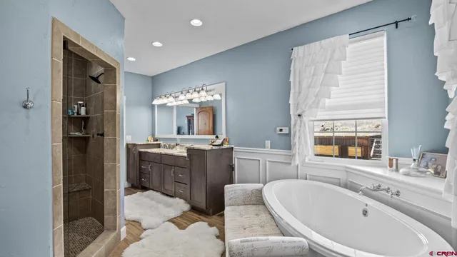 a bathroom with a granite countertop sink a large mirror and a toilet