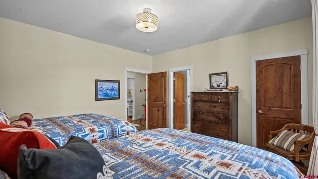 a bedroom with two beds and a closet