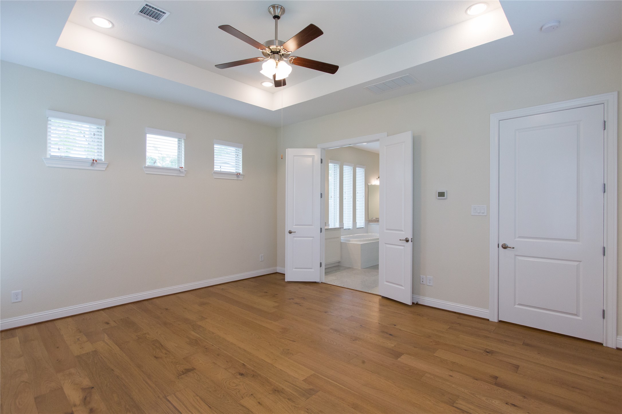 7402 Kearney Hill Lane Spring, TX 77389 - Photo 11 of 23 an empty room with wooden floor ceiling fan and windows