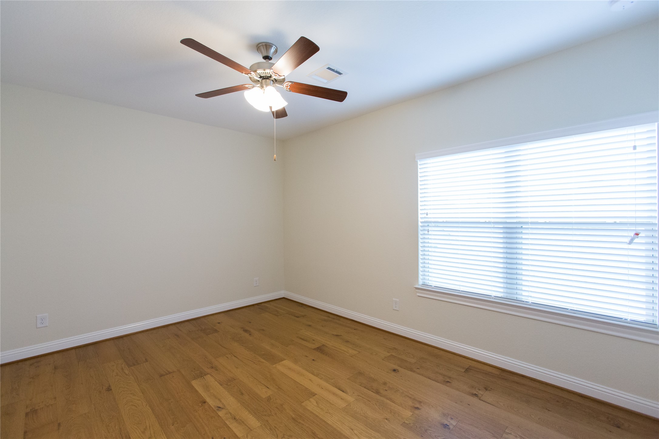 7402 Kearney Hill Lane Spring, TX 77389 - Photo 20 of 23 an empty room with a window and a ceiling fan