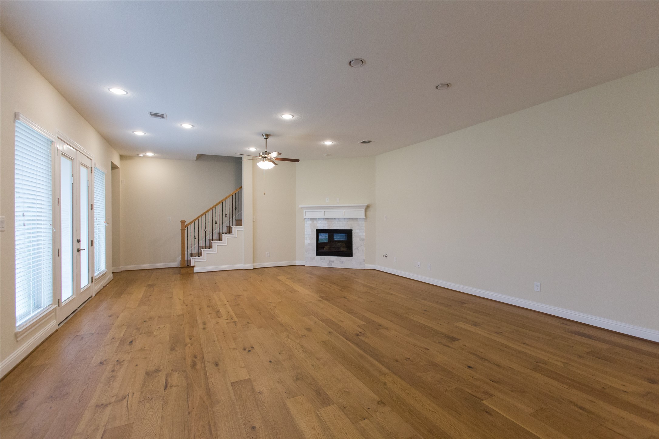 7402 Kearney Hill Lane Spring, TX 77389 - Photo 8 of 23 an empty room with wooden floor and a ceiling fan