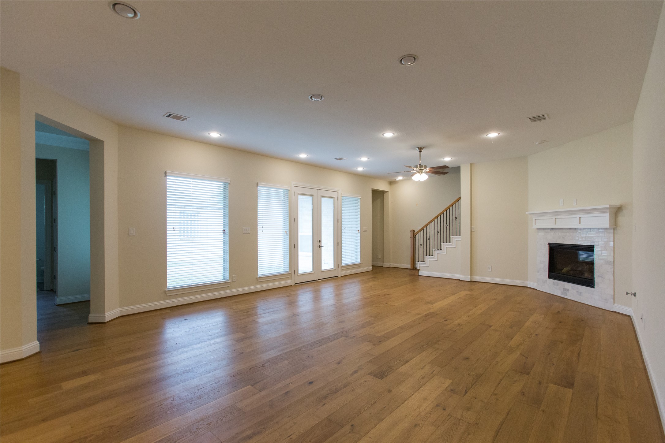 7402 Kearney Hill Lane Spring, TX 77389 - Photo 9 of 23 a view of an empty room with wooden floor and a window