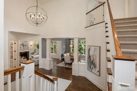 a living room with furniture a fireplace and a chandelier