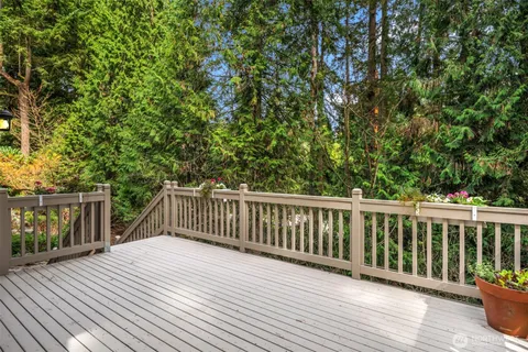 a balcony with wooden floor and fence