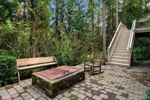 a view of a backyard with sitting area
