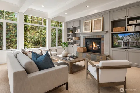 a living room with furniture a fireplace and windows