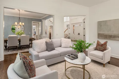 a living room with furniture and a chandelier