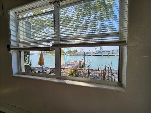 a room with a large window and pool table
