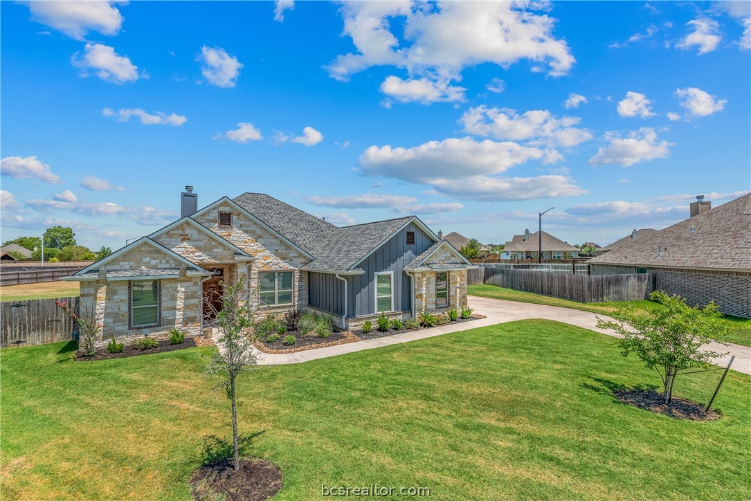 a front view of a house with a garden and plants