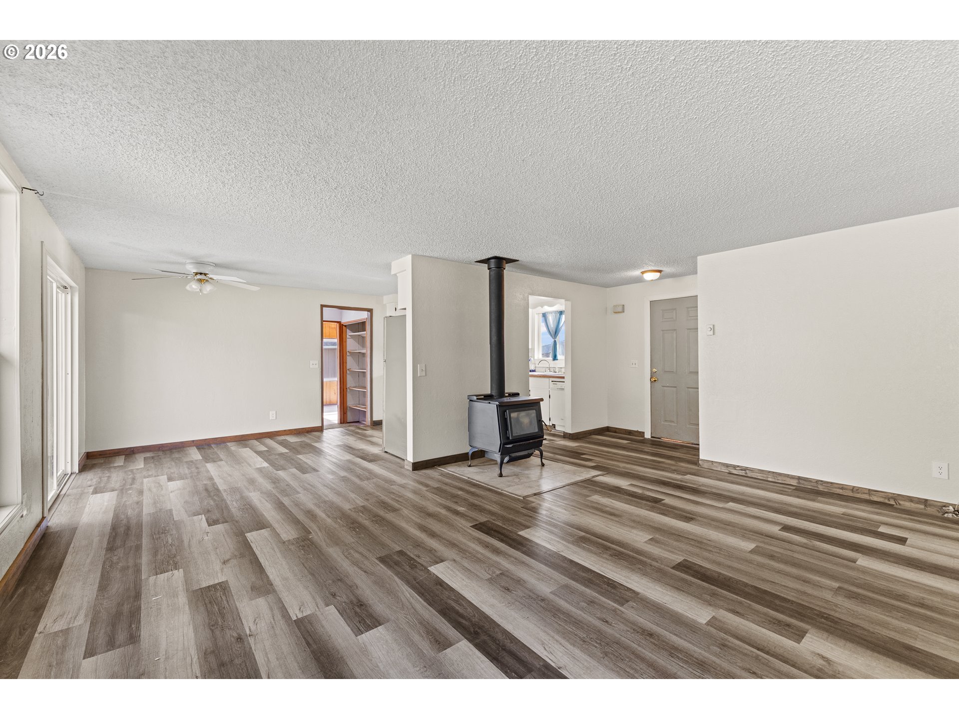 1816 Sunset Court Myrtle Point, OR 97458 - Photo 20 of 42 a view of an empty room and window and wooden floor