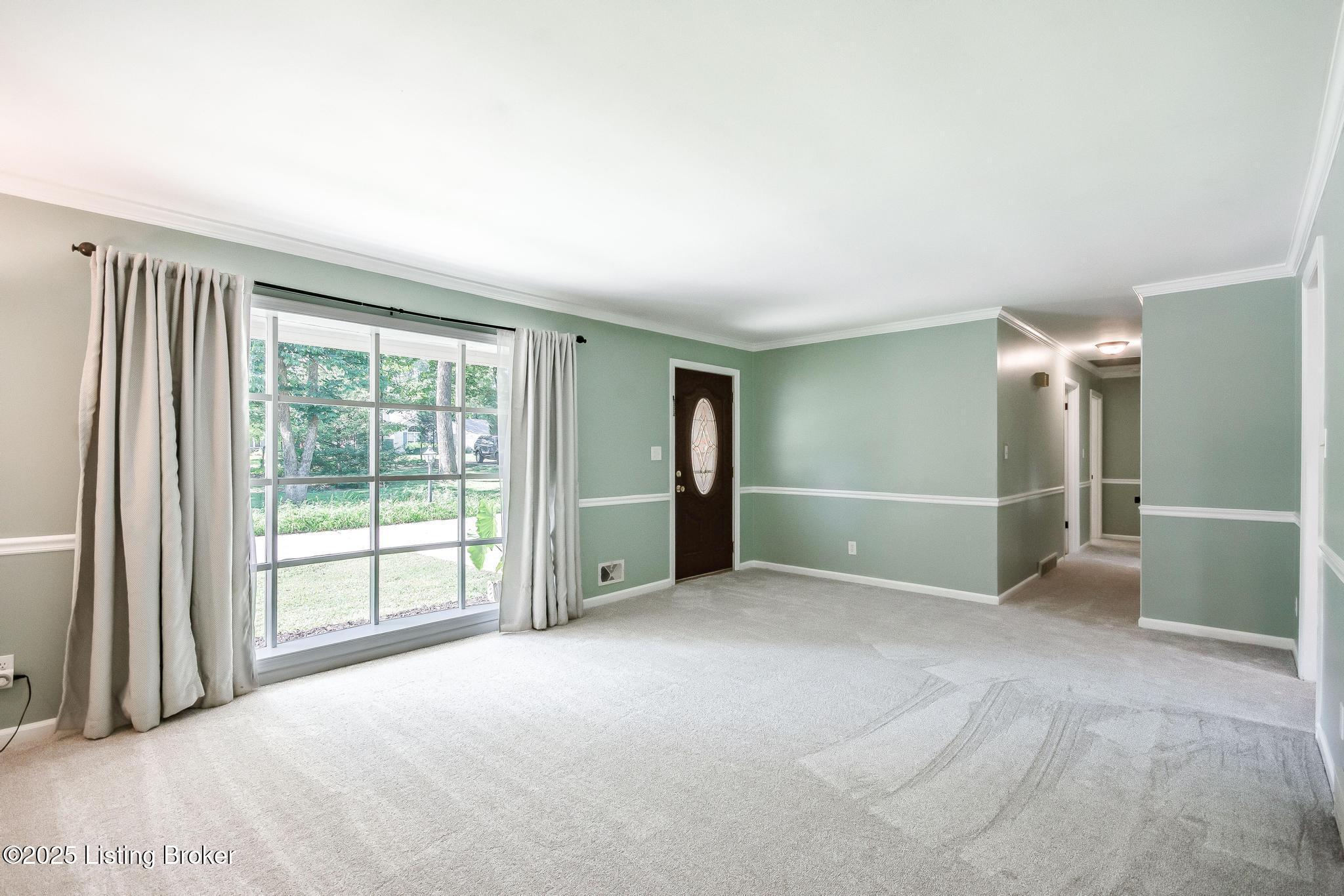 9611 Fairground Road Louisville, KY 40291 - Photo 7 of 57 Living Room with new carpet, large window overlooking front acreage, crown molding, chair rail and open to the Dining Room.