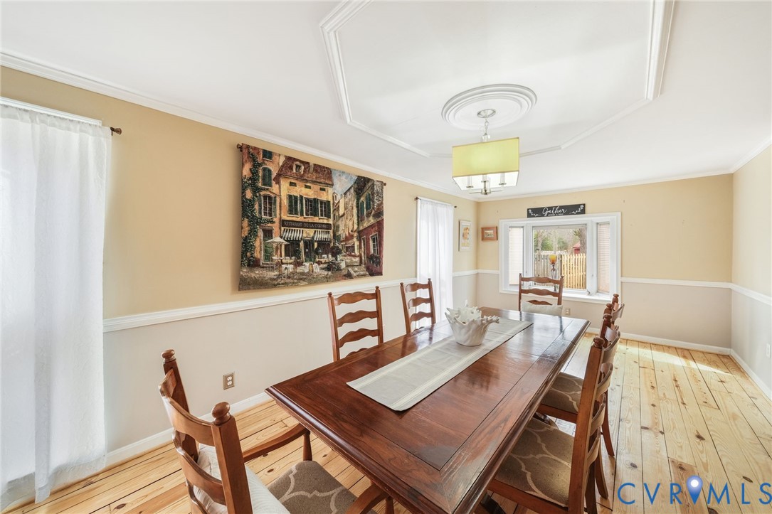 844 Monarch Shores Road Kilmarnock, VA 22482 - Photo 12 of 54 a view of a dining room with furniture and chandelier