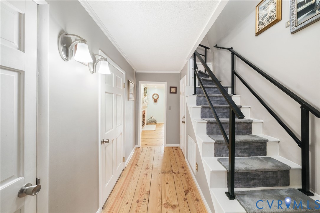 844 Monarch Shores Road Kilmarnock, VA 22482 - Photo 19 of 54 a view of staircase with lots of frames on wall and wooden floor