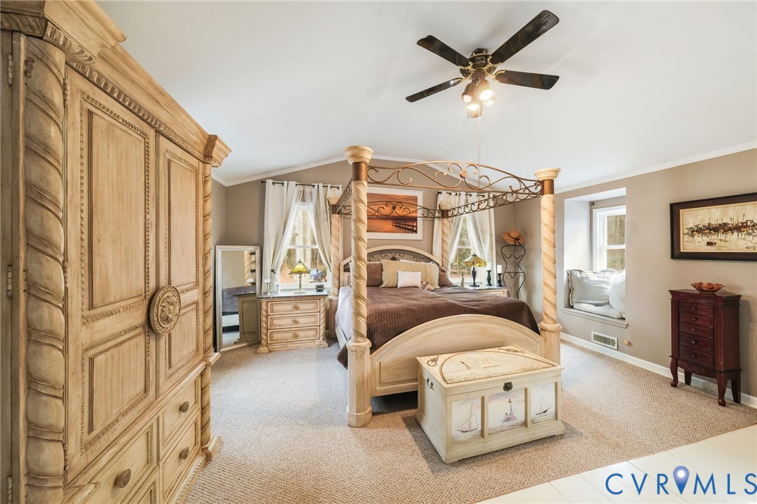 844 Monarch Shores Road Kilmarnock, VA 22482 - Photo 20 of 54 a living room with furniture a ceiling fan a flat screen tv and a window