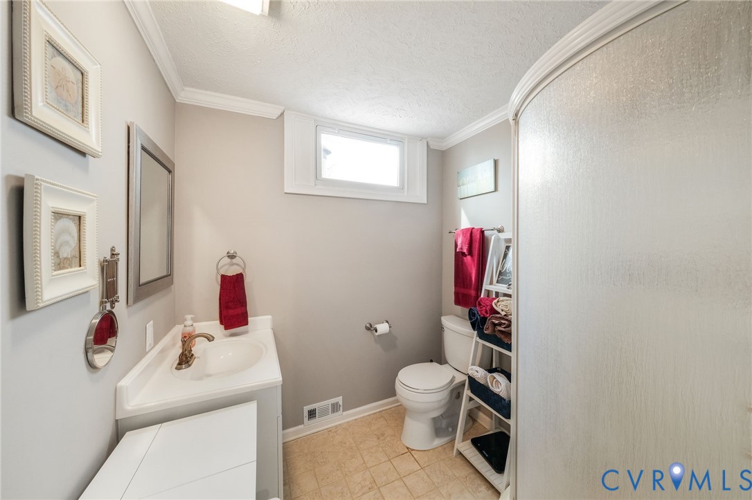 844 Monarch Shores Road Kilmarnock, VA 22482 - Photo 24 of 54 a bathroom with a toilet sink tub and mirror