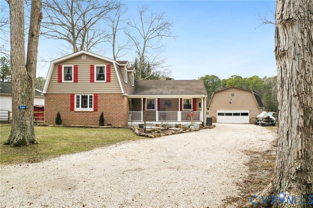 844 Monarch Shores Road Kilmarnock, VA 22482 - Photo 28 of 54 a front view of a house with a yard and garage