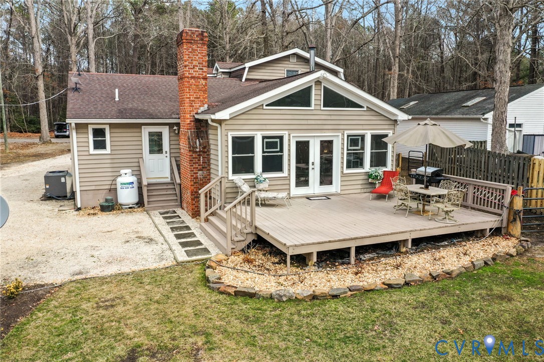 844 Monarch Shores Road Kilmarnock, VA 22482 - Photo 30 of 54 a front view of a house with a yard patio and fire pit