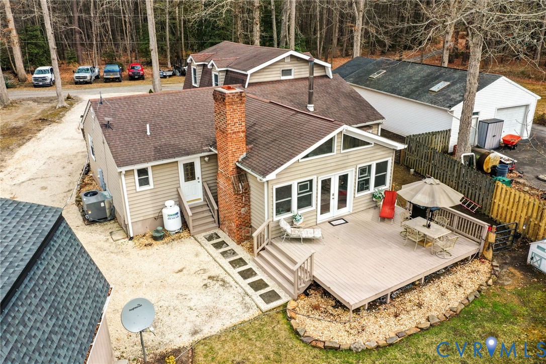 844 Monarch Shores Road Kilmarnock, VA 22482 - Photo 30 of 54 a view of a white house with table and chairs