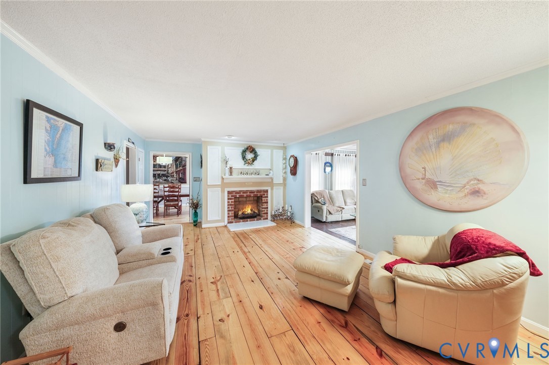 844 Monarch Shores Road Kilmarnock, VA 22482 - Photo 3 of 54 a living room with furniture a couch and a fireplace